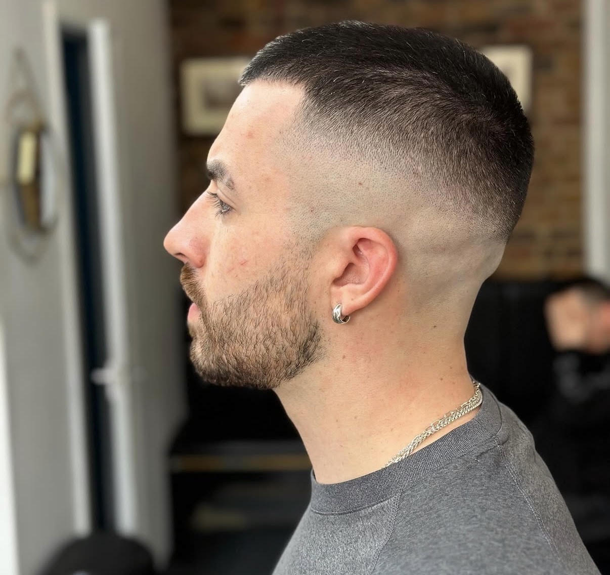 High skin fade with a sharp lineup and beard blend