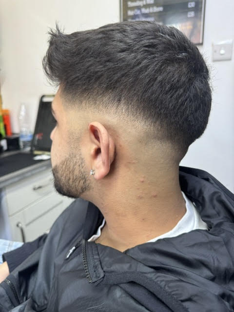 Textured top over a mid skin fade